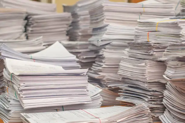 Photo of pile of paper documents in the office