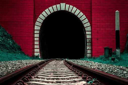 Front of old railway tunnel entrance, surreal color