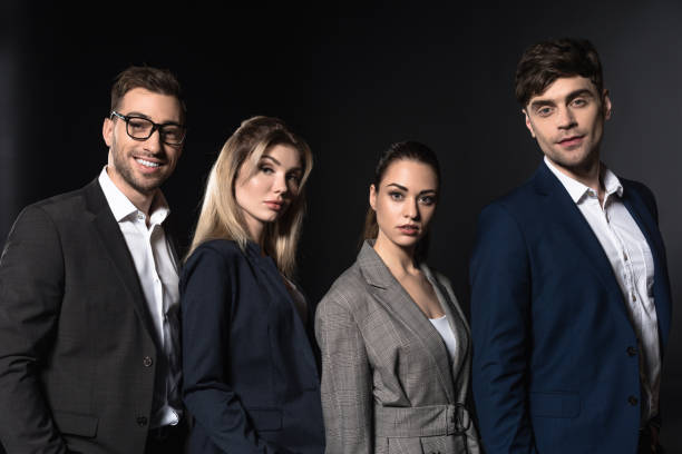 istock group of confident business people looking at camera together while standing in row isolated on black 1068404988