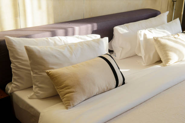 istock Pillows and bed sheets in luxury room with sunlight in the morning 1068410090