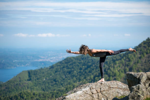istock Yoga exercises in nature on mountains: warrior 3 pose 1068410212