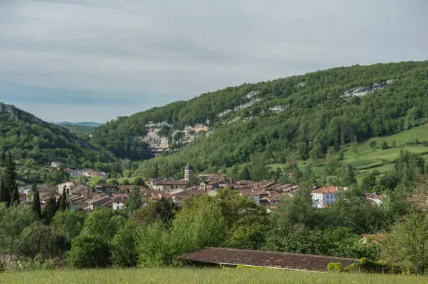 View towards ancient town in Ariege, France, with blue sky and mountains in background