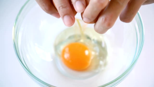SLOMO Female hands Break an egg.