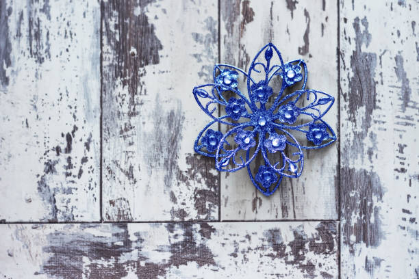 Christmas blue star on a white wooden background with copy-space