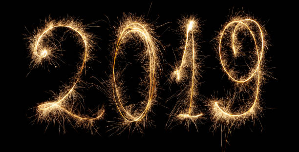 istock 2019 new year. it's a firework. glowing inscription. isolation on black background 1068412792