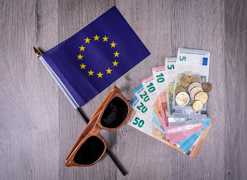 Euro \t€ notes and coins.  Travel Money with sunglasses.