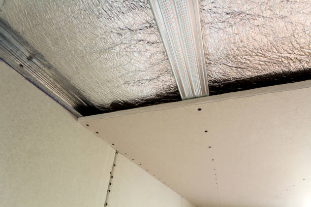 istock Room under construction with silver aluminum insulation foil and drywall on walls and ceiling. 1068419302