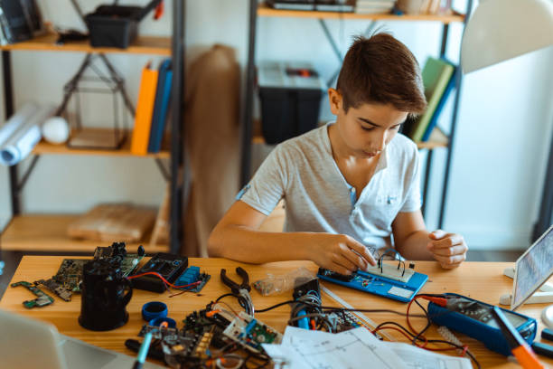 istock Boy electrician repairing computer motherboard 1068420366