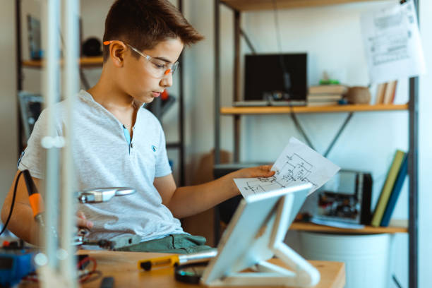 istock Boy electrician repairing computer motherboard in laboratory 1068420678