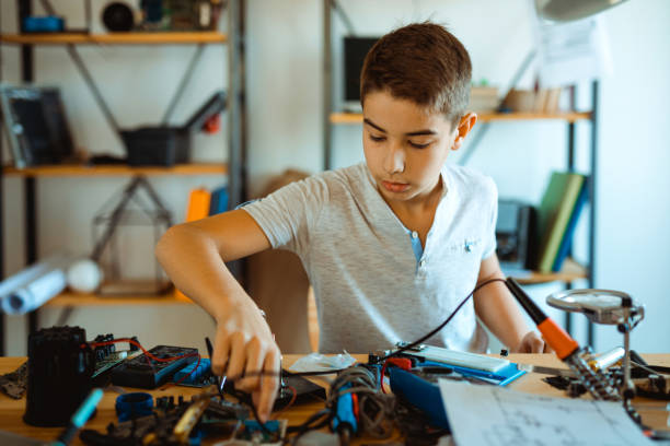 istock Boy electrician repairing computer motherboard in laboratory 1068420772