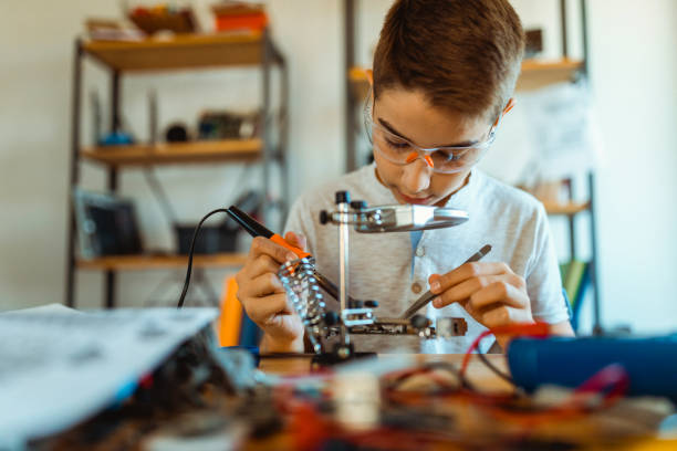 istock Boy electrician repairing computer motherboard 1068422274