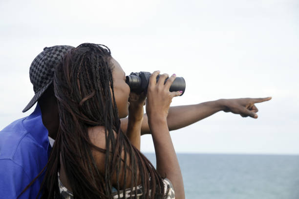 Romantic african couple with binoculars