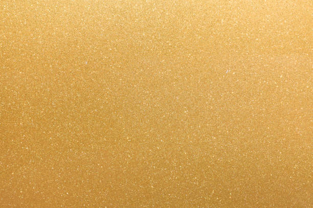 istock Golden glitter orange yellow surface with blinking white irregular spots, copy space background. 1068423166
