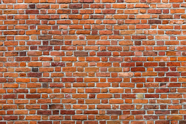 istock Natural old vintage weathered red brown solid brick wall. Abstract copy space background. 1068424410