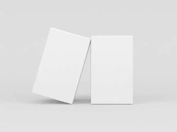 Photo of Two White textured boxes packaging mockup for fragrance or perfume isolated in gray studio