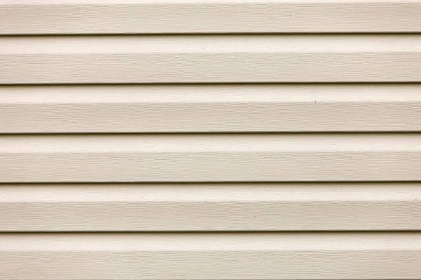 istock Close-up of brown new gutter metal system pipe on wall. Drain protection, professional work concept. 1068424620