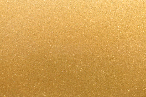 istock Golden glitter orange yellow surface with blinking white irregular spots, copy space background. 1068424772