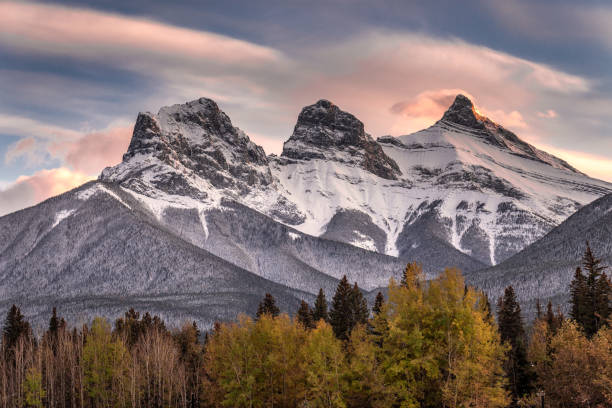Banff National Park Sunset light just hitting the top of the Three Sister peaks near Canmore, Alberta, Canada foothills photos stock pictures, royalty-free photos & images