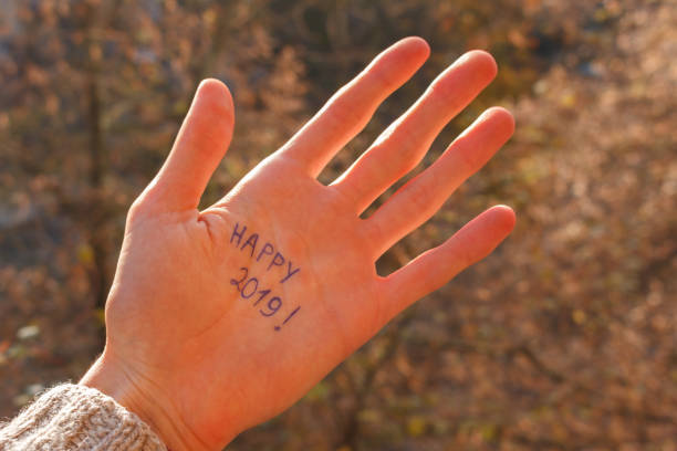 istock the sun's rays fall on the male hand with happy 2019 title 1068425554