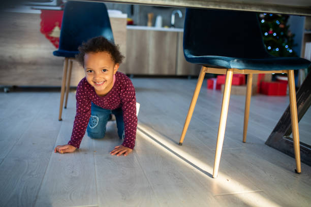 istock Cute Girl Crawling Through Living Room 1068433556