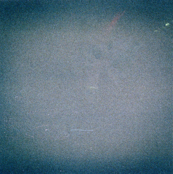 istock Noisy blue film frame with scratches, dust and grain 1068433568