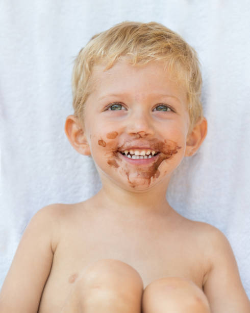 istock Infant boy with chocolate on his face 1068435586