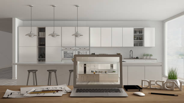 istock Architect designer desktop concept, laptop on wooden work desk with screen showing interior design project, blueprint draft in the background, modern minimal kitchen 1068436558