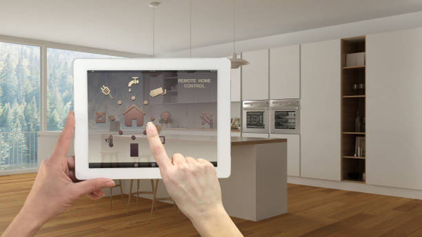 istock Smart remote home control system on a digital tablet. Device with app icons. Modern minimalist white and wooden kitchen in the background, architecture interior design 1068438164