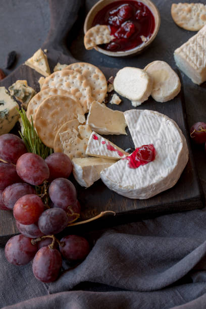 istock Different types of cheese with grape on wood board 1068439092
