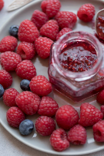 istock Raspberry jam in jar with raspberry and blueberry near 1068439134