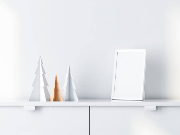 istock Christmas trees decor with White photo frame Mockup on bureau 1068441916