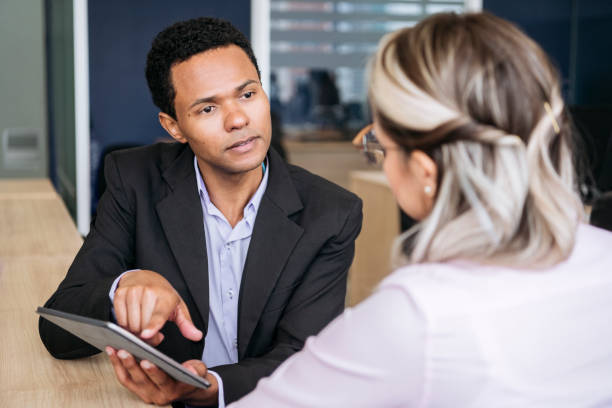 istock Businessman with tablet explaining to colleague 1068445182