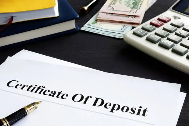 Photo of Certificate of deposit and pen in the office.