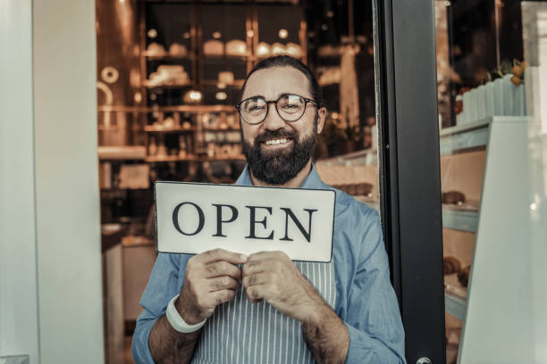 istock Positive nice man inviting to his cafe 1068445558
