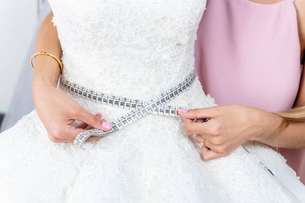 woman measuring waist on wedding dress - mannequin dressmakers model tape measure female imagens e fotografias de stock