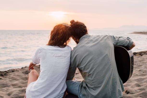istock Romantic couple looking at sunset at the beach 1068449544