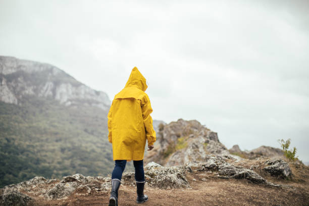 istock Woman hiking alone on a rainy day 1068452694