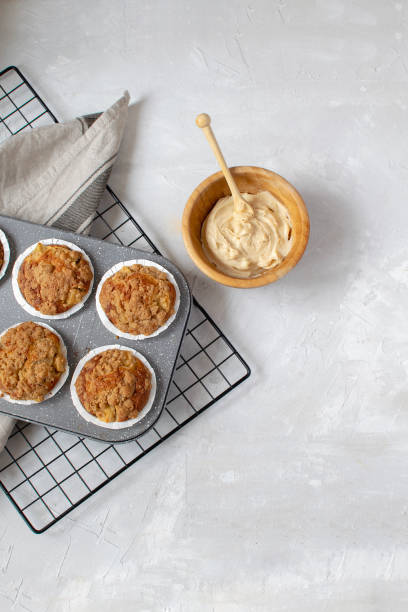 istock Homemade baking - fresh baked apple muffins on cooling rack 1068453110