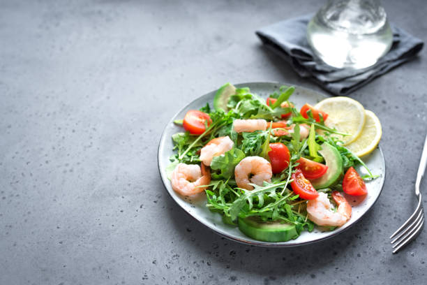 istock Avocado Shrimp Salad with Arugula and Tomatoes 1068454400
