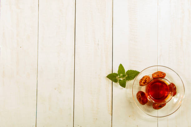 istock A cup of tea on a white table.Traditional Arabic, Turkish Ramadan tea with dry dates and raisins on a wooden white table. Turkish fresh tea with dates. Ramadan kareem. Ramadan background. 1068454766