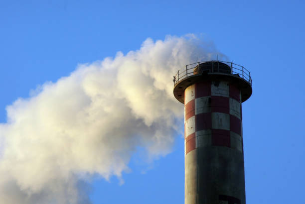 smoke pulls from industry chimney - incinerator imagens e fotografias de stock