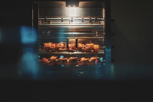 Chicken roasting in commercial rotisserie oven