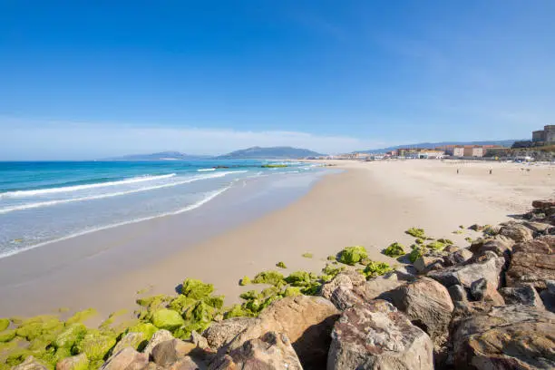 landscape of beautiful sandy great Los Lances Beach, from the breakwater rocks, in Tarifa town, Cadiz, Andalusia, Spain