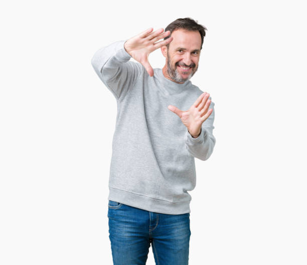 istock Handsome middle age senior man wearing a sweatshirt over isolated background Smiling doing frame using hands palms and fingers, camera perspective 1068469770