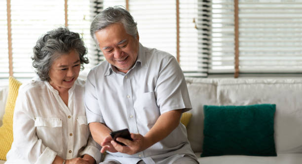 istock Happy Asian senior Couple using smartphone. 1068472976