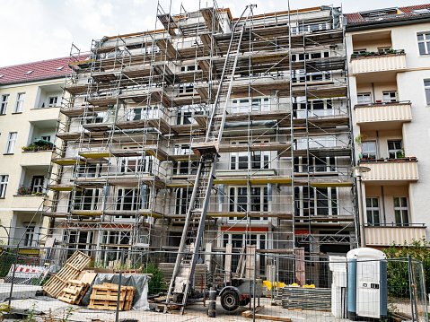 Scaffold surrounding new building completion of construction