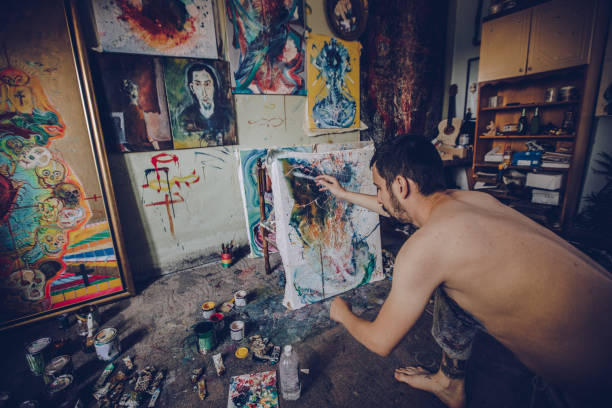 istock Shirtless artist painting 1068479116
