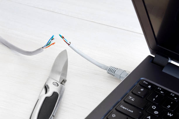 istock Internet cable, laptop and pocket knife 1068486792