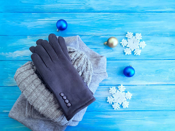 istock sweater, gloves, hat on a wooden background 1068487800