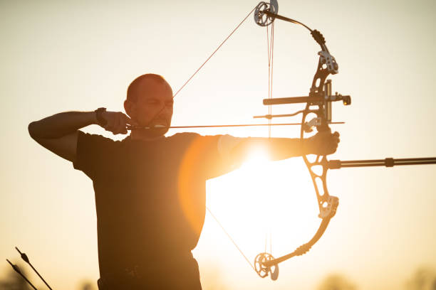 istock Man with prosthetic arm doing archery outdoors 1068496266